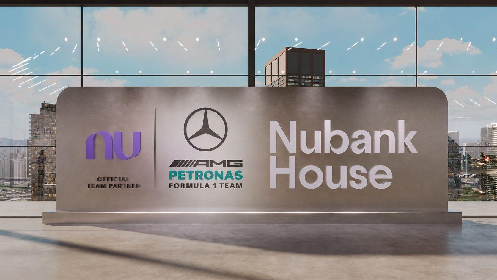 Palco da Nubank House com o carro da Mercedes-AMG sobre uma plataforma, diante do painel com os pilotos
